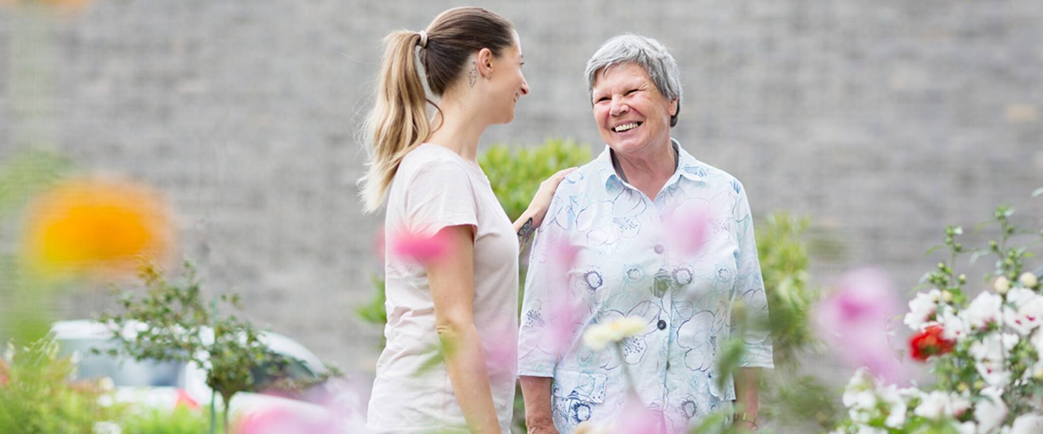 assisted living resident is comforted by senior health care workers