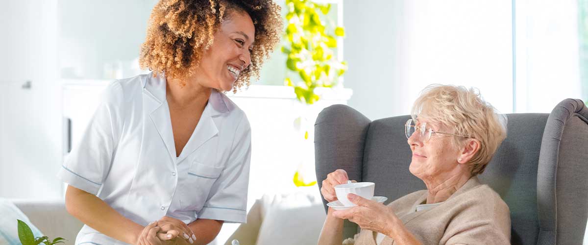 Nurse with older woman in her senior living home