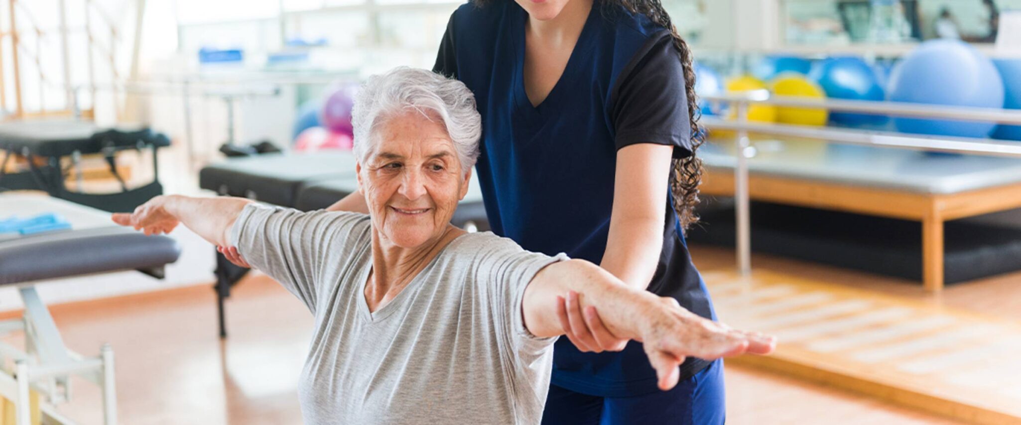 An occupational therapist helps a senior woman