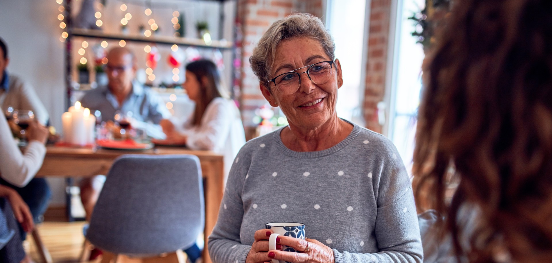 happy senior lady talking with a younger woman in a cafe