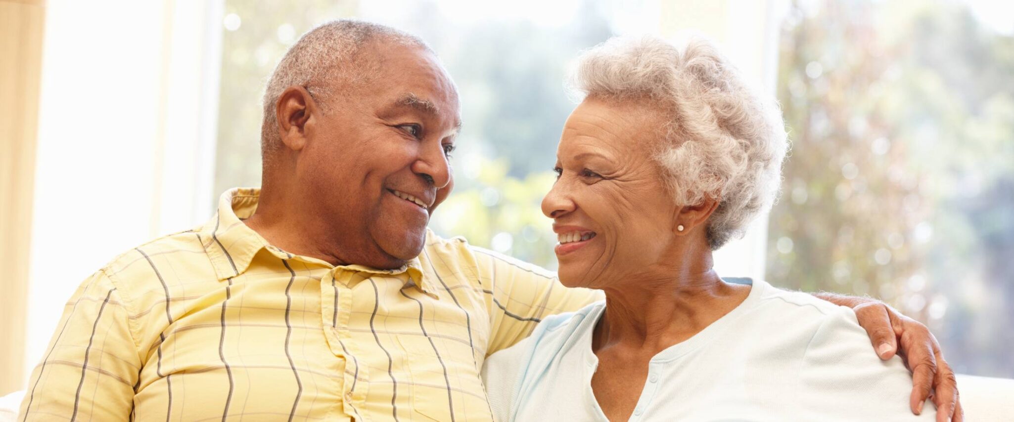 senior couple looking at one another while smiling