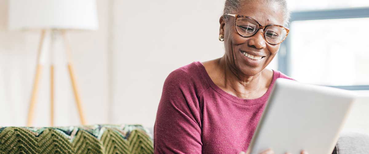 Senior woman using an iPad in her senior living home