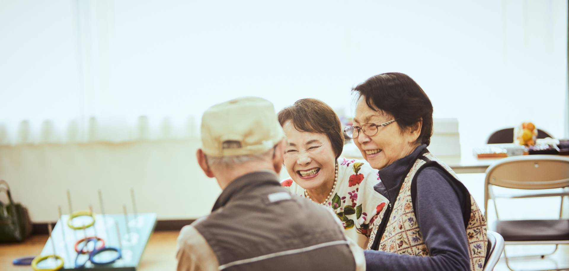 seniors being social and enjoying a game at a senior living community