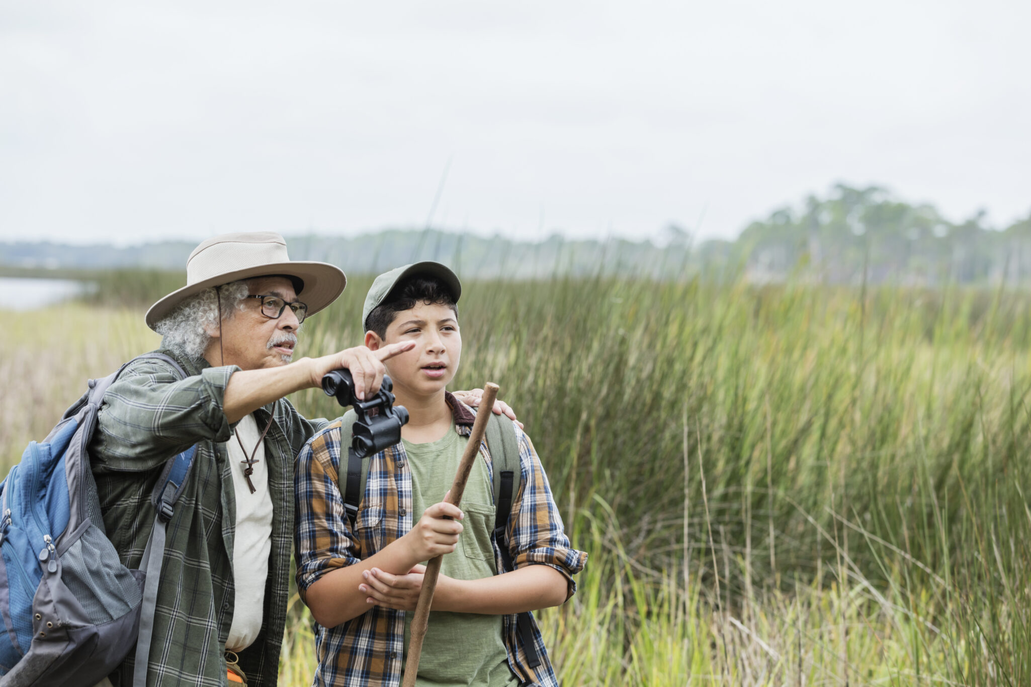 A boy and his grandfather are hiking in the Florida glades