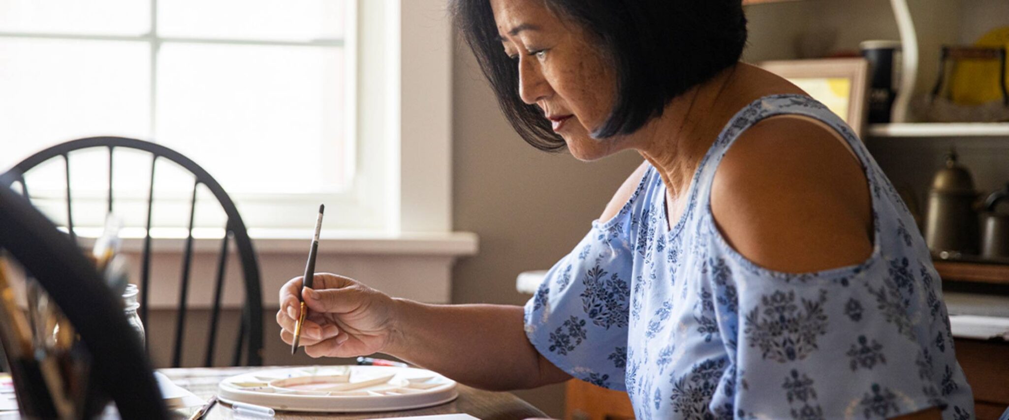 senior lady working on a water color painting