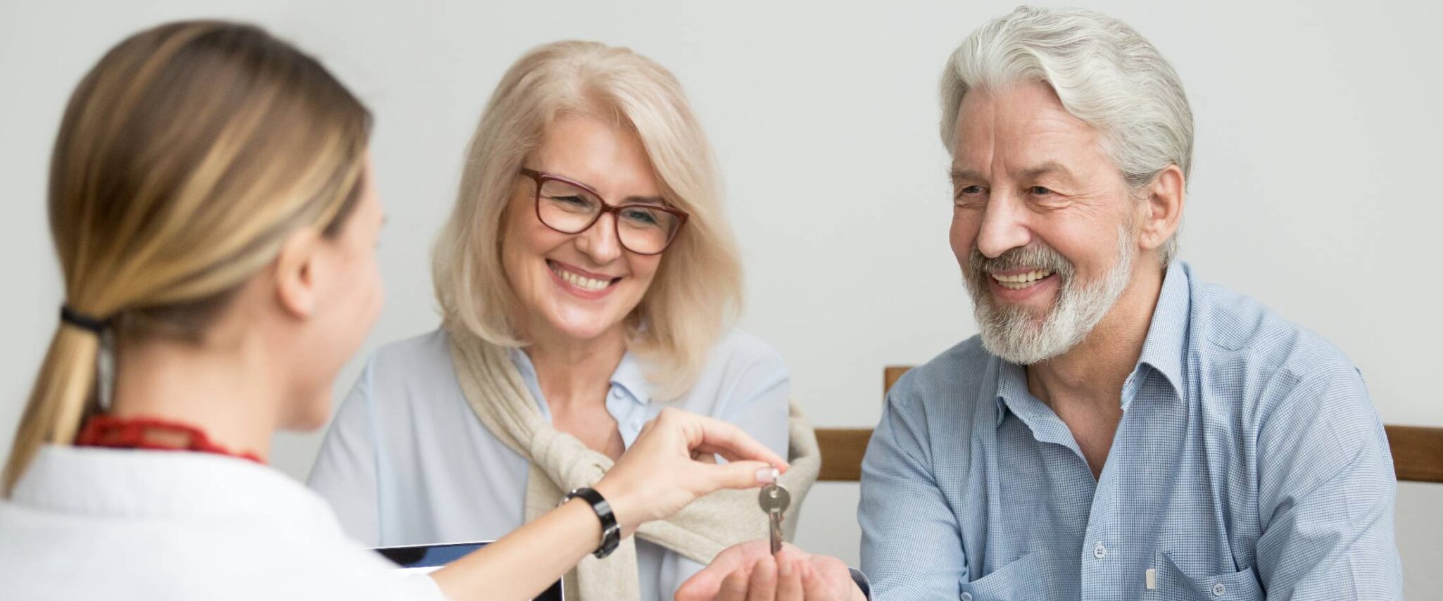 senior couple receiving keys to their new senior home