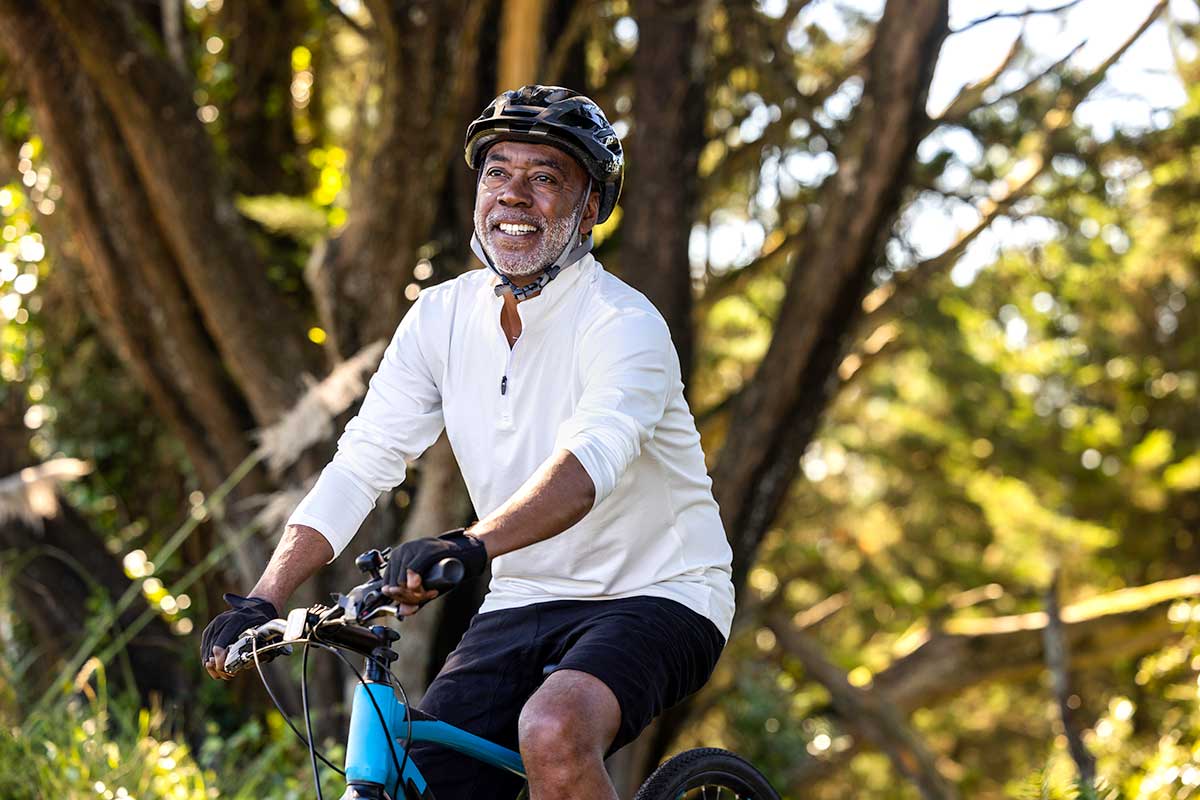 A man riding a bicycle in a wooded area