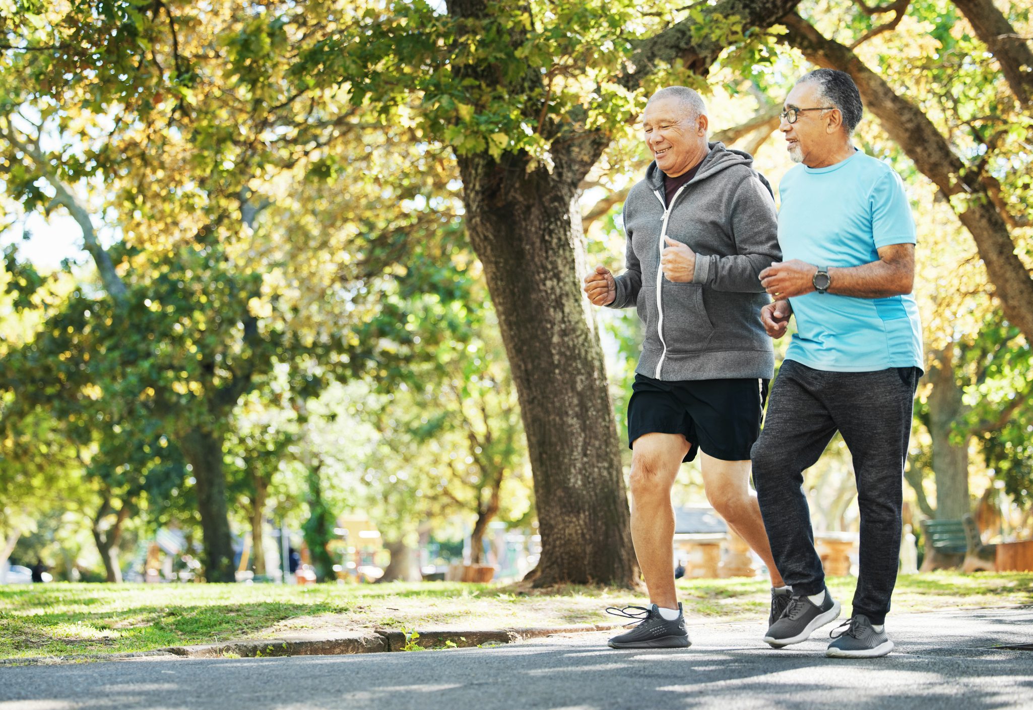 Two senior men on a run in a park